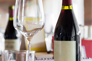 Elegant Wine Glass with Wine on a Ta, a Food & Drink Photo by KYNA STUDIO