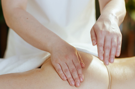 Closeup on medical massage therapist massaging clients buttocks, a Health & Medical Photo by Alliance Images