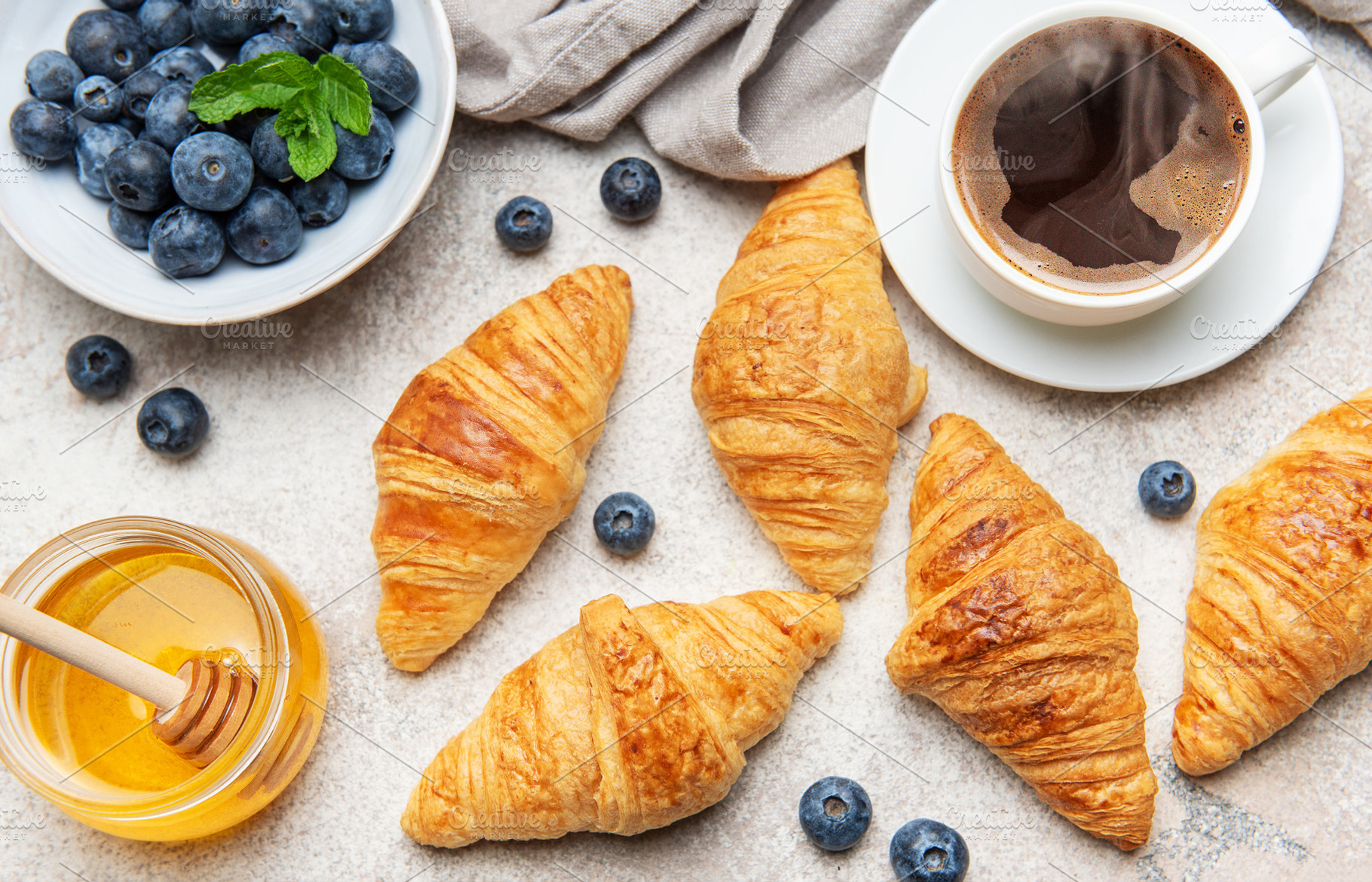 Delicious continental breakfast with croissants, coffee, honey a, a Food & Drink Photo by Olena Rudo