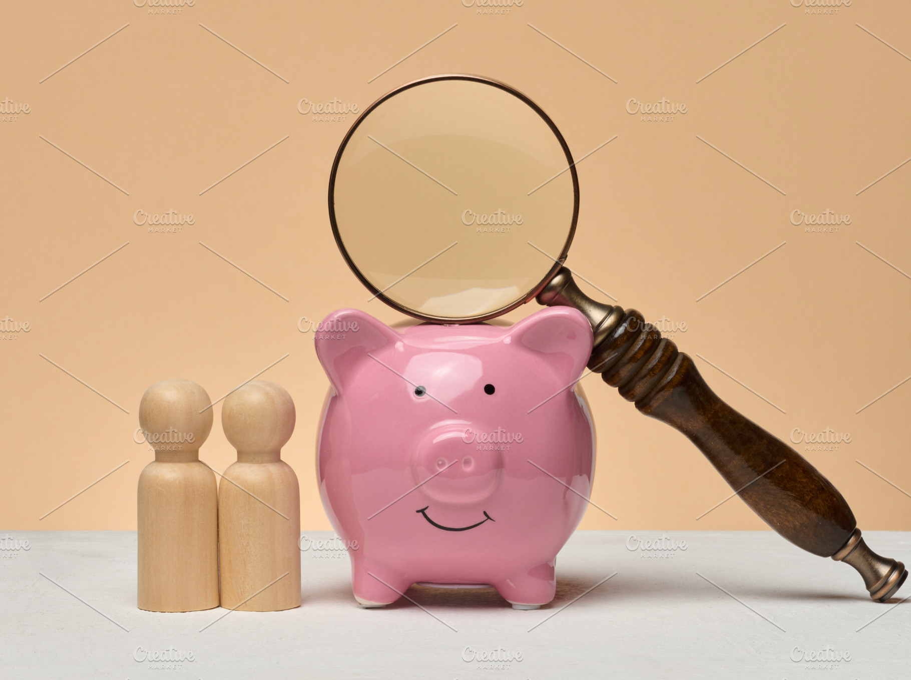Piggy bank, wooden human figures, above the piggy bank there is, a Business Photo by ndanko