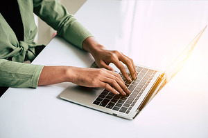 Closeup of woman hand working at home office and typing on keybo