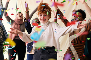 Action shot of young white woman celebrating International Women's Day with fri