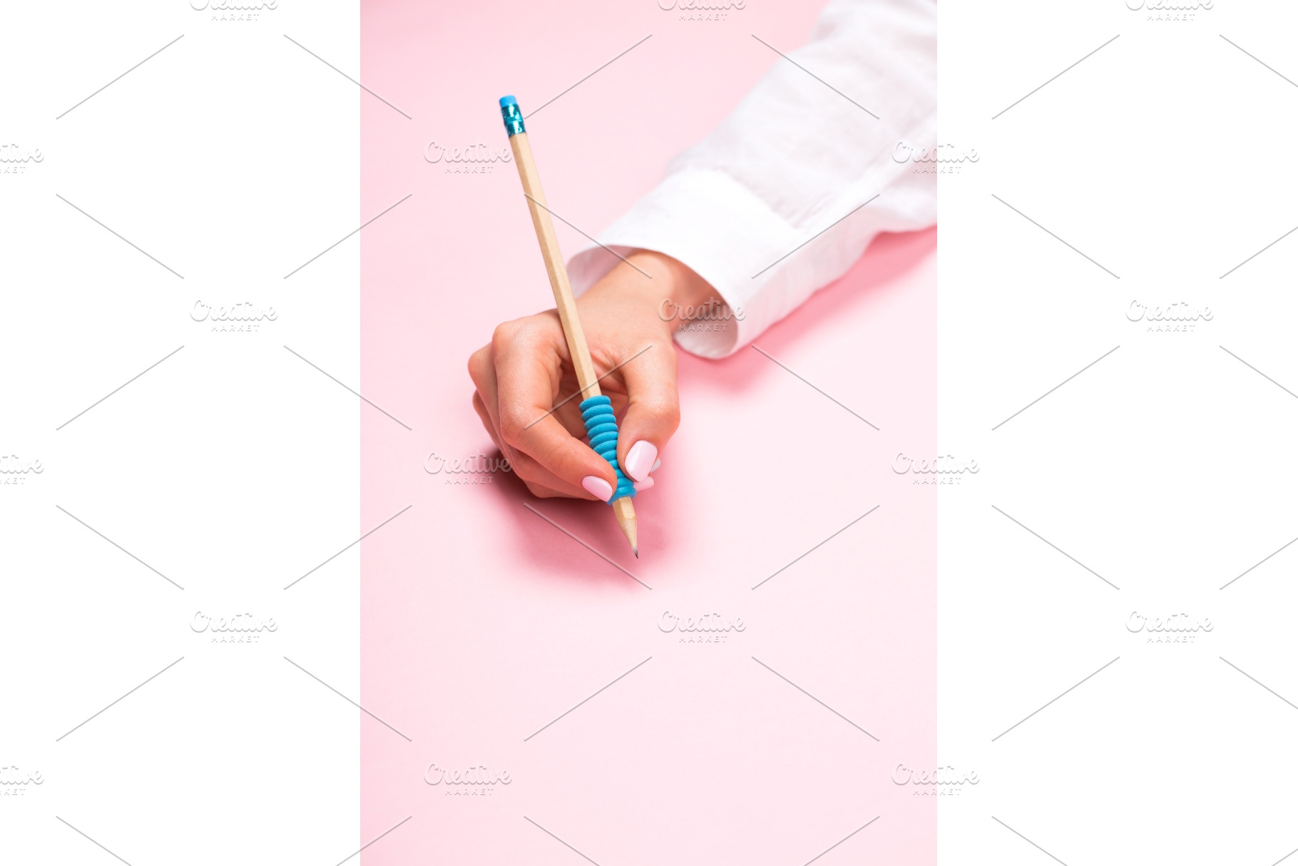 Hand holding pencil on pink, a Business Photo by Anna Efetova