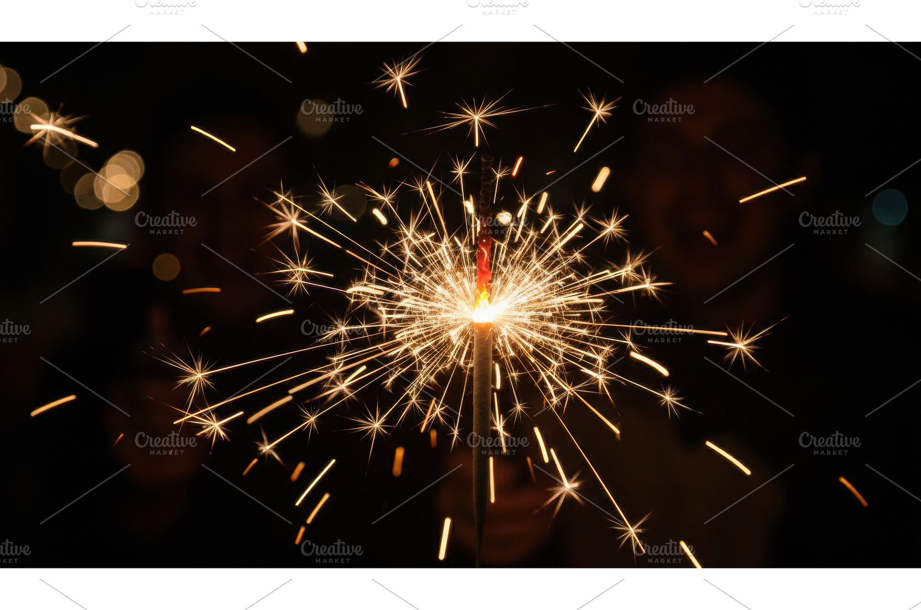 Hand holds a single, lit sparkler, a Holiday Photo by Igor Tichonow