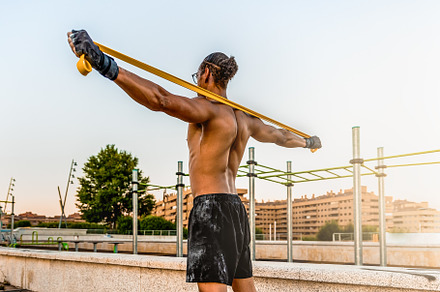 Man exercising with resistance band, a Sports & Recreation Photo by Perpis