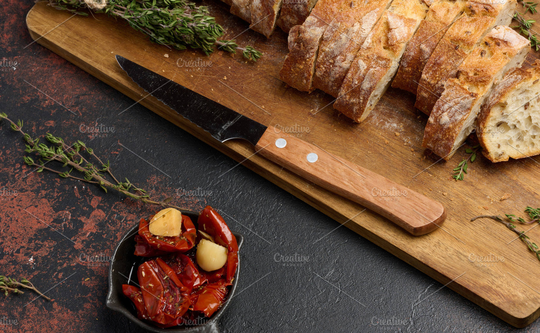 Sun dried tomatoes in a bowl and sliced ciabatta pieces on the t, a Food & Drink Photo by ndanko