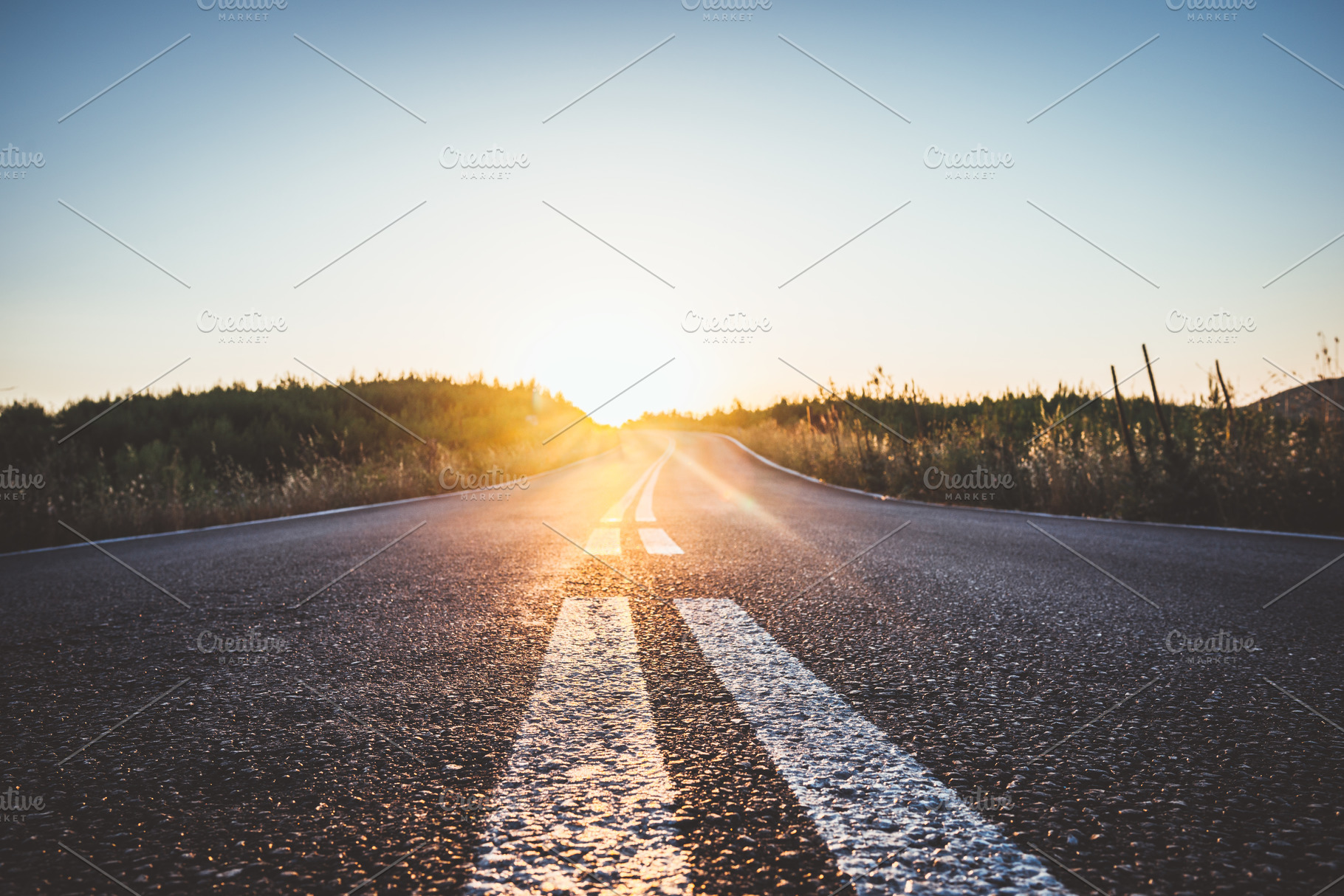 Asphalt road in mountains at sunset featuring road, sunset, and highway, a Nature Photo by Juicy Photography