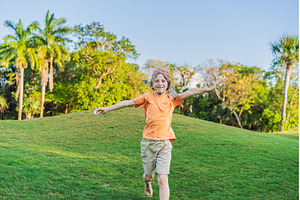 Boy wearing a pilot hat running, a Nature Photo by Elizaveta Galitskaya