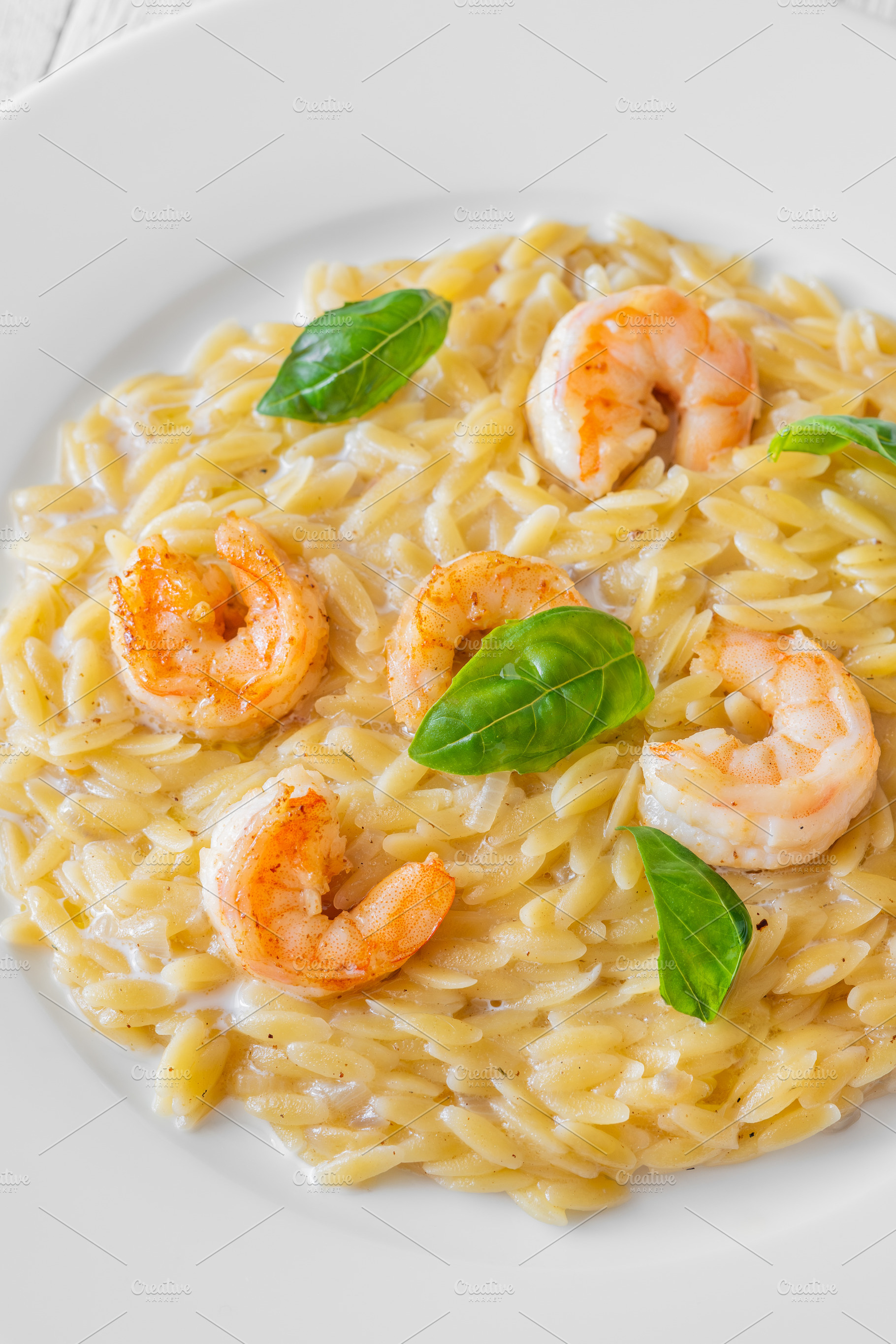Creamy orzotto pasta topped with gri, a Food & Drink Photo by Alexander Prokopenko