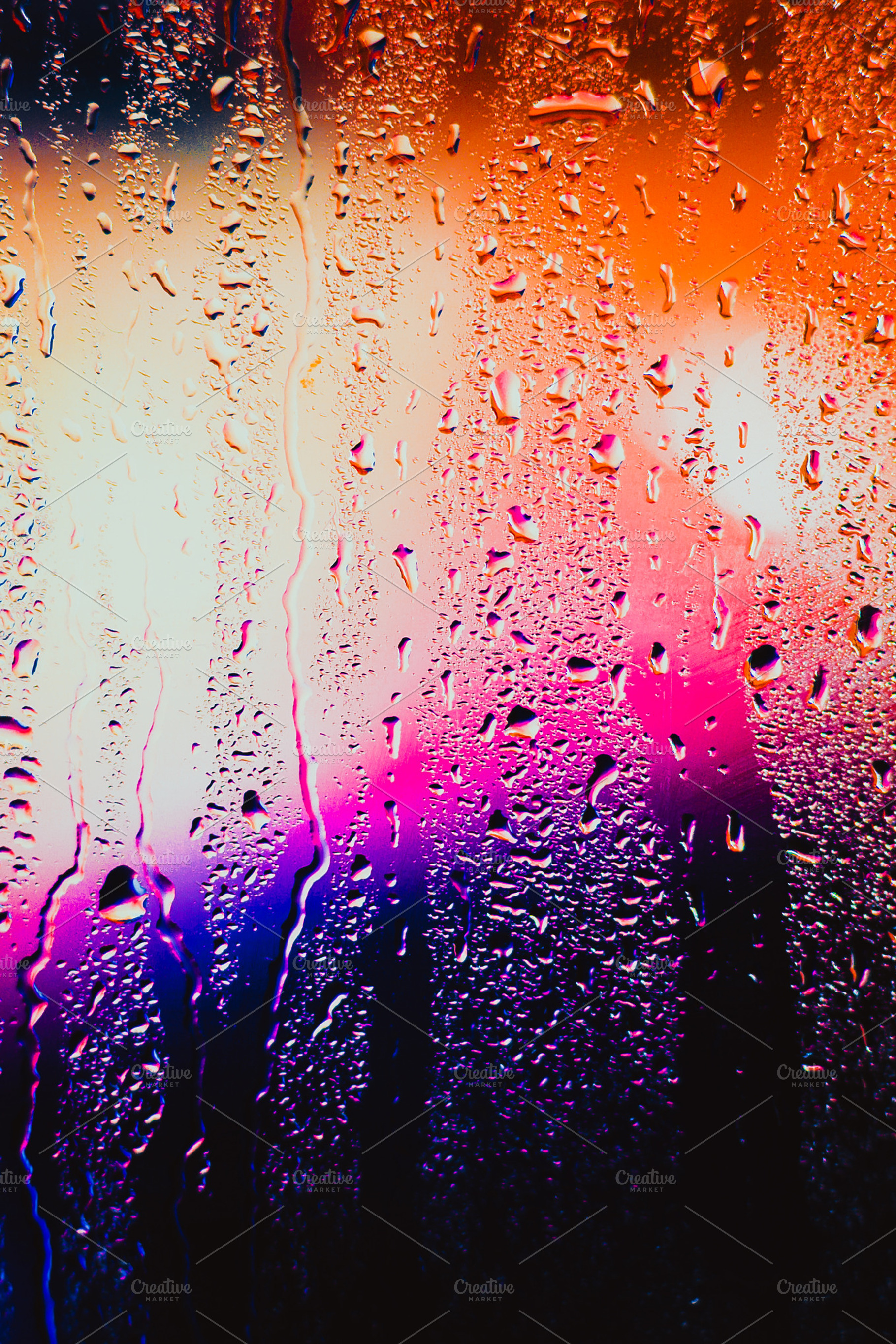 Raindrops on a blurred multicolored background containing abstract, drop, and, an Abstract Photo by ruslan117
