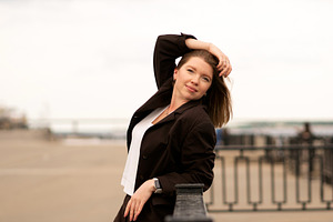 Woman in brown suit resting arm, a Person Photo by Elena Vagengeim