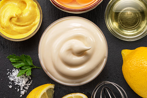 Homemade mayonnaise and mayo ingredients on black stone slate se, a Food & Drink Photo by Volff