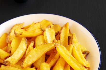 Homemade French Fries on a Plate on a black background, side vie, a Food & Drink Photo by LiudmylaChuhunova