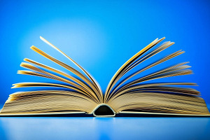 Open book on bright blue background, a School & Education Photo by MistyDay