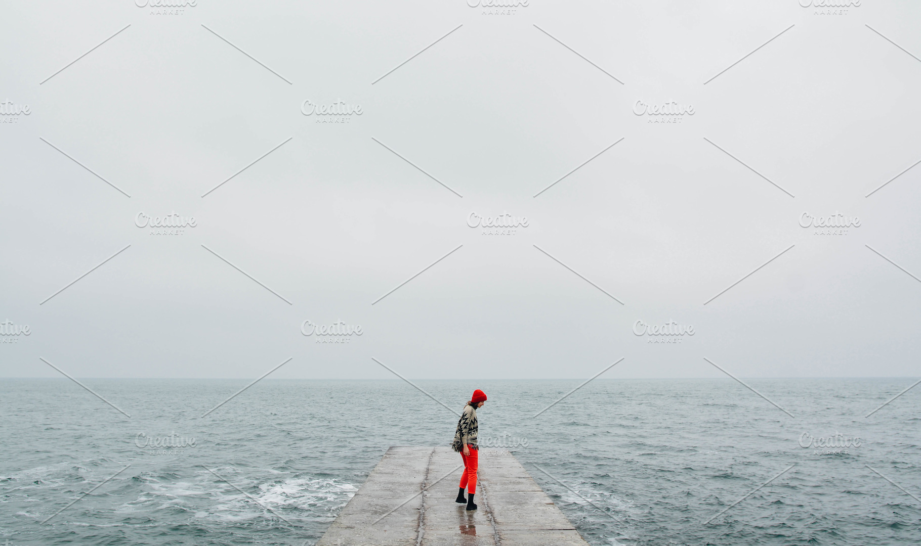 Girl on the concrete at winter sea featuring winter, alone, and beach, a Person Photo by Pro.Motion