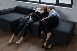 Two women napping on sofa in, a Person Photo by undrey