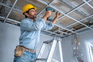 Construction worker installing ceili, a Photo by Pixeness Studio