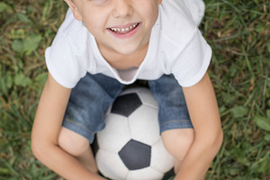 Young boy with soccer ball stock photo containing sport and football