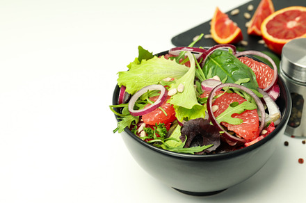 Concept of tasty food, salad with red orange, space for text, a Food & Drink Photo by AtlasStudio