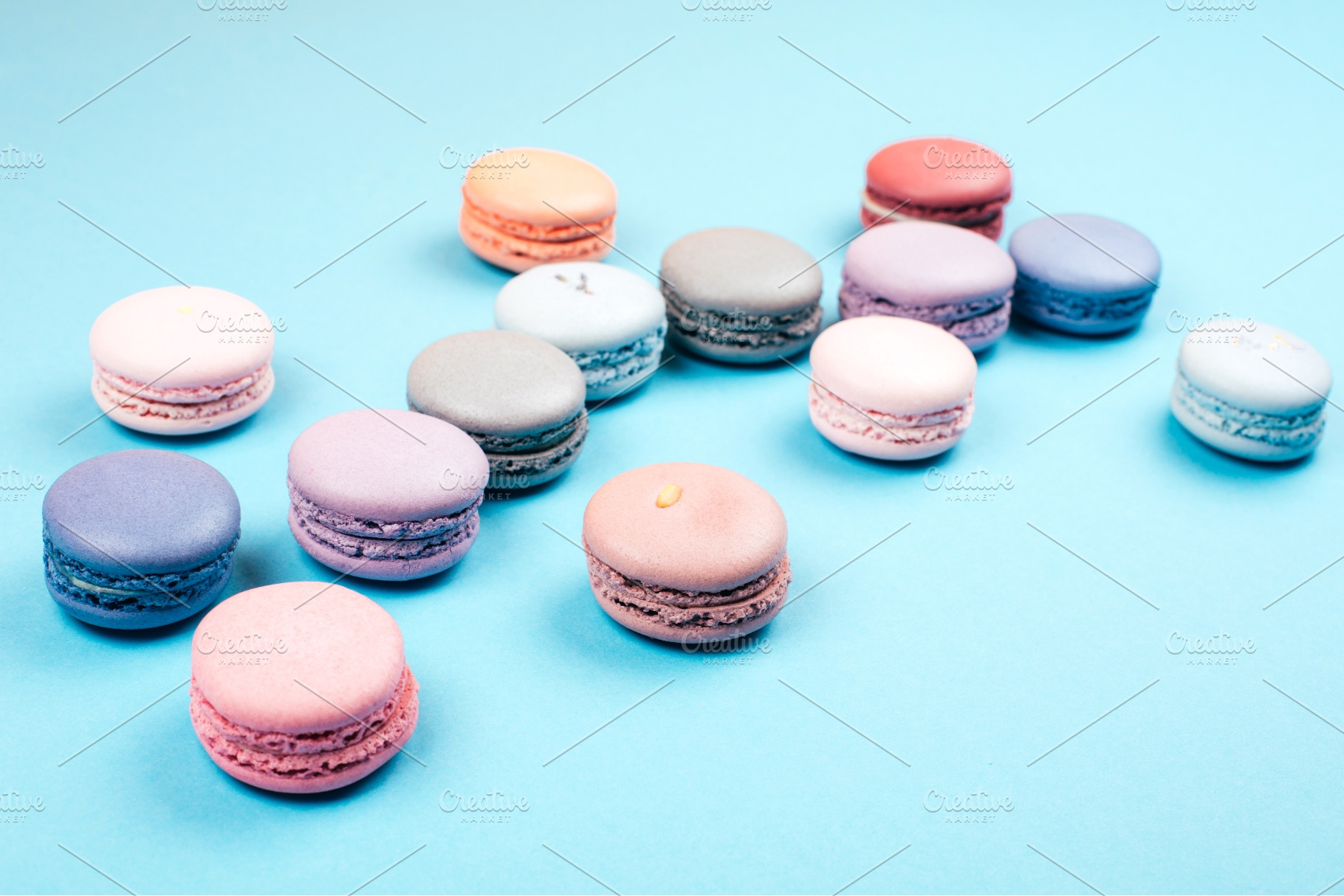 Assorted pastel macarons scattered, a Food & Drink Photo by Anna Efetova