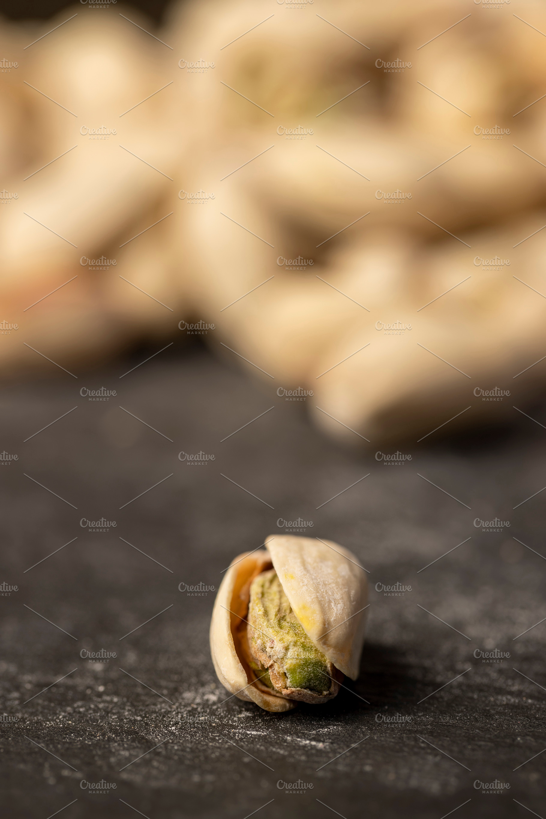 pistachios with green nuts inside, the salted pistachios on the table, a Photo by rsoollAI