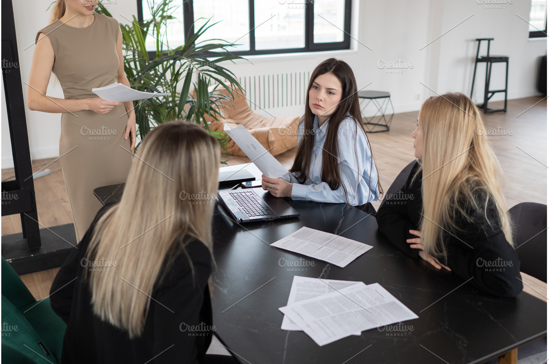 Three businesswomen are discussing, a Business Photo by undrey