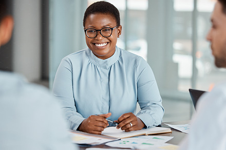 Planning meeting, business partnership and black woman with smile for marketing team strategy, work communication and happy with office collaboration. African manager talking to employees at company, a Photo by Peopleimages.com