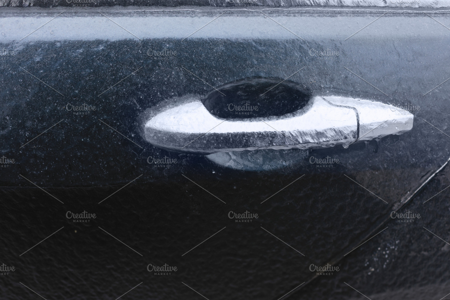 Close-up of an icy car door handle covered in frost, showcasing, a Transportation Photo by Ales Munt