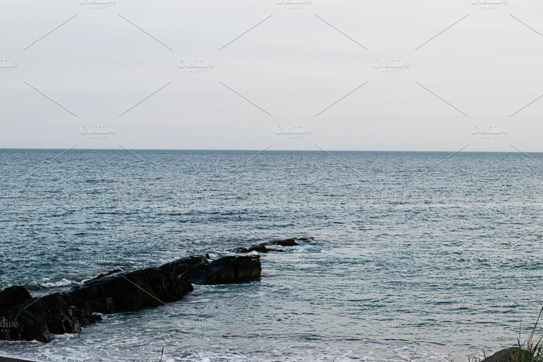 Serene coastal view from Akranes, Iceland under a calm, overcast sky, a Photo by AS photostudio