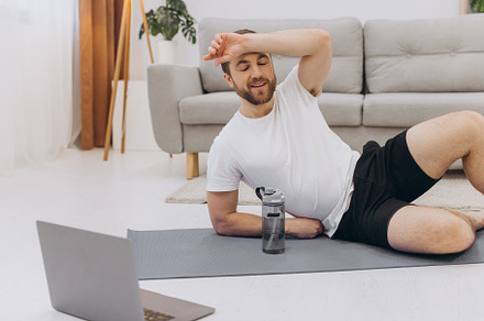 Handsome adult man using laptop and drinking water while having, a Sports & Recreation Photo by Cherkas Photography