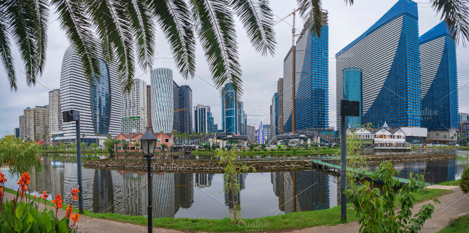 Modern skyscrapers skyline reflected in lake water with palm tre, a Photo by Pictures for you!!!!!!!!!