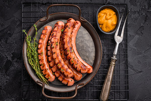 Grilled and cut sausages (frankfurters/wieners) on a rustic plat, a Food & Drink Photo by composter-box@mail.ru