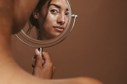 Woman looking in the mirror, a Person Photo by Jacob Lund