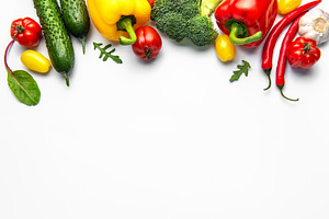Fresh organic vegetables creating healthy eating border on white, a Food & Drink Photo by Olena Rudo