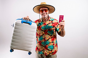 Traveler holding passport and luggage, a Holiday Photo by karrastock
