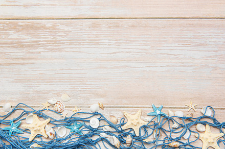 Fishing net with starfishes and seashells creating summer holida