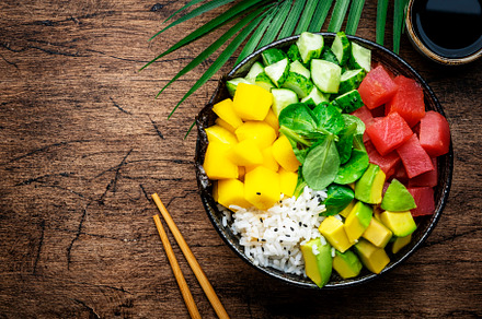 Poke bowl with fresh tuna, avocado, mango, cucumber, lettuce and, a Food & Drink Photo by 5PH