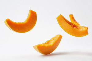 Floating orange melon slices capture, a Photo by Tanuart