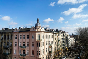 Historic architecture of Krakow Poland under bright blue sky with scattered clo, a Photo by AS photostudio