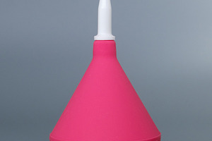Pink medical syringe bulb with a white plastic tip on a grey background. Dispos, a Health & Medical Photo by Rohan Photography