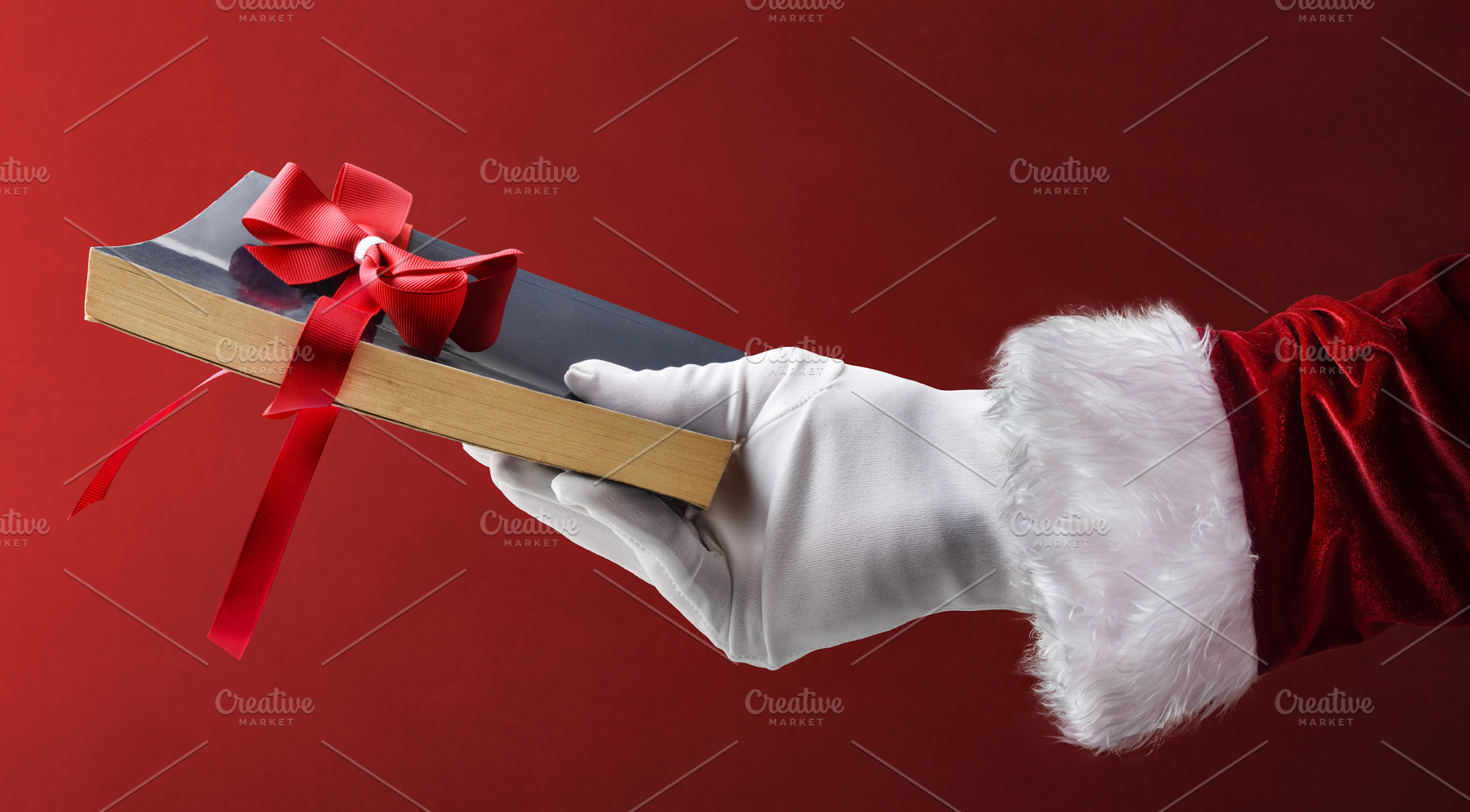 Give a book as a Christmas gift with Santa's hand, a Holiday Photo by Davizro's Market