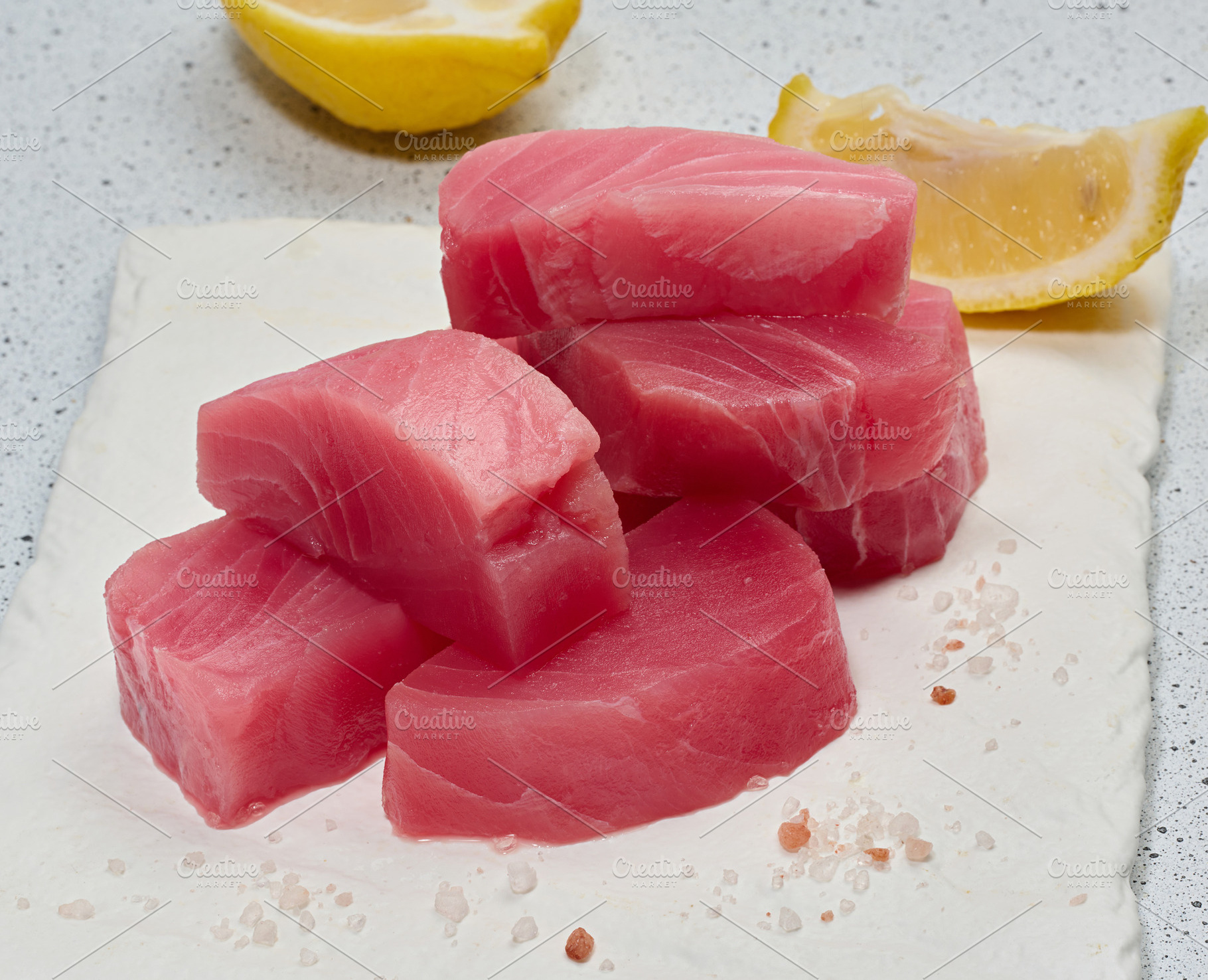 A stack of raw tuna pieces on a white board, a Food & Drink Photo by ndanko