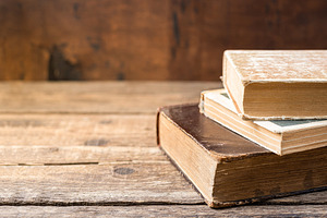 Old books on wooden shelf