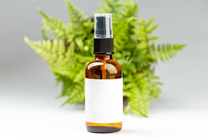 Glass spray bottle with white label