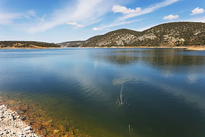 Serene mountain lake with blue refle, a Nature Photo by Perpis