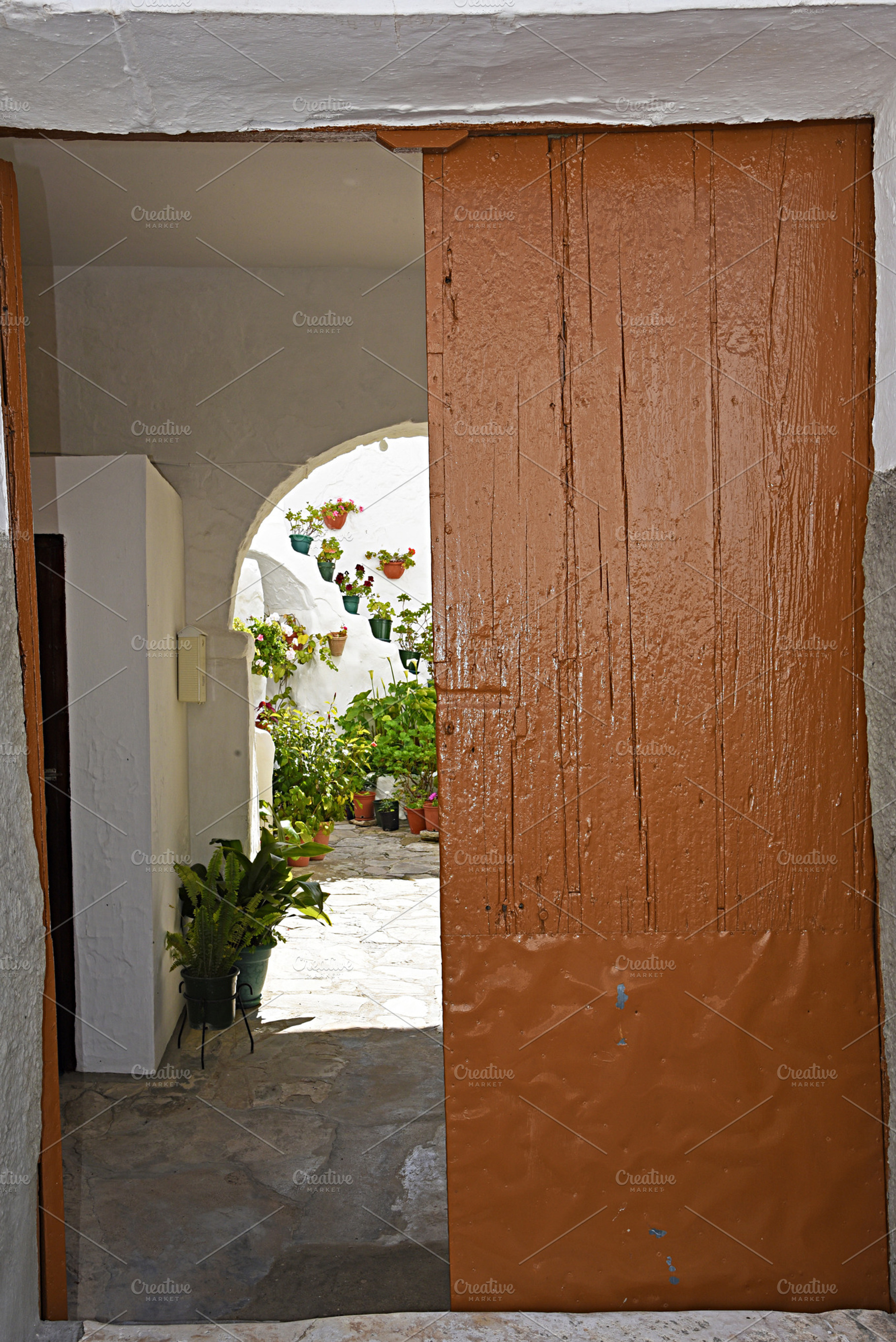 An andalusian patio entrance containing patio, planters, and stone, an Architecture Photo by neftali77