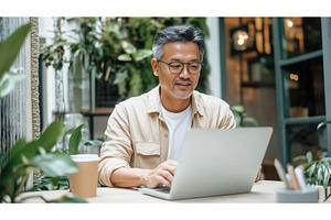 Asian businessman working on a, a Person Photo by Sergey Kotenev