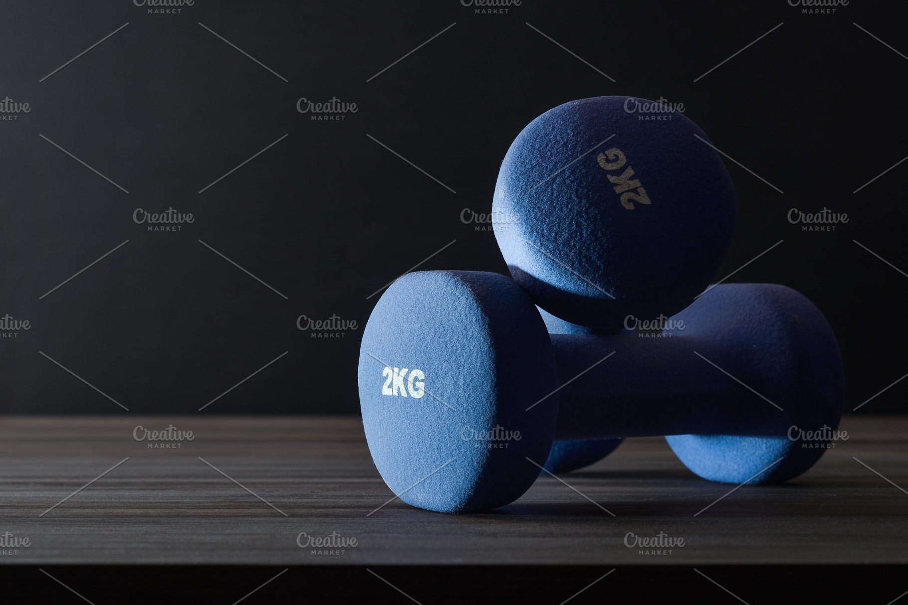 Sports concepts with two dumbbells on table with dark background, a Sports & Recreation Photo by Davizro's Market