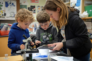 Exploring science together two young, a Photo by Pavel_design