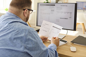 Man Comparing Bill and Screen